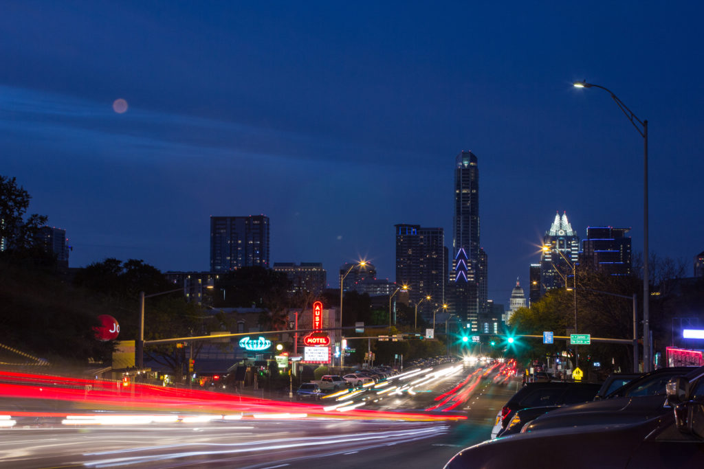 Night photo of South Congress Street in Austin, Texas with red and yellow car lights in the foreground because of the long exposure