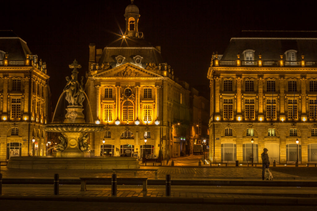 Night photo of a fountain and buildings at Place de la Bourse in Bordeaux, France
