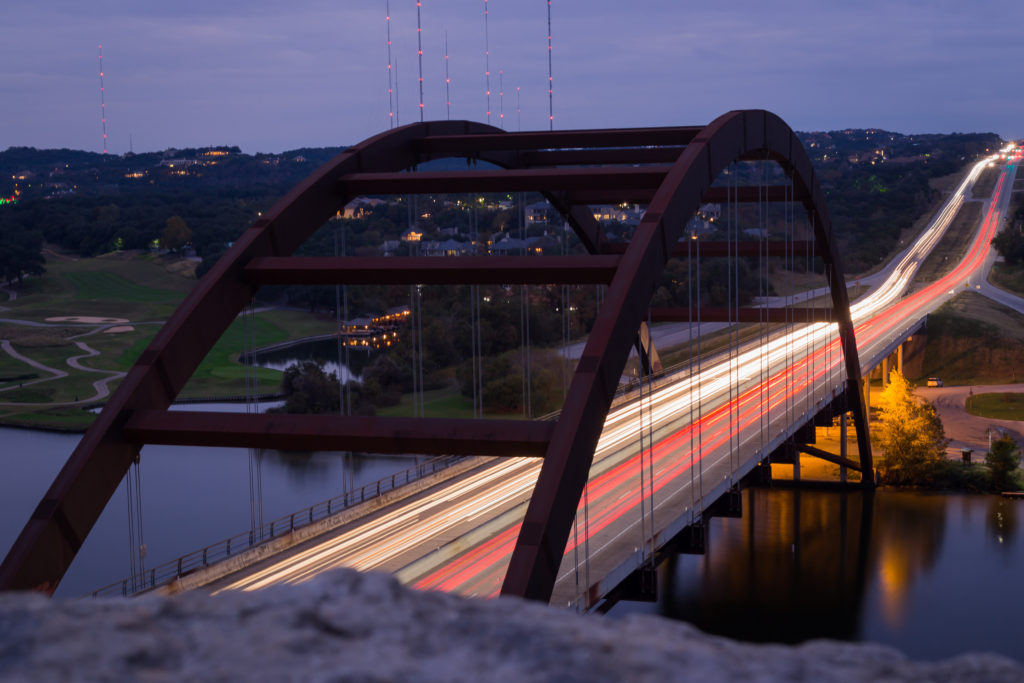 night photo of cars over the 360 bridge in Austin, Texas